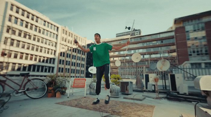 a man in a green shirt is holding a frisbee