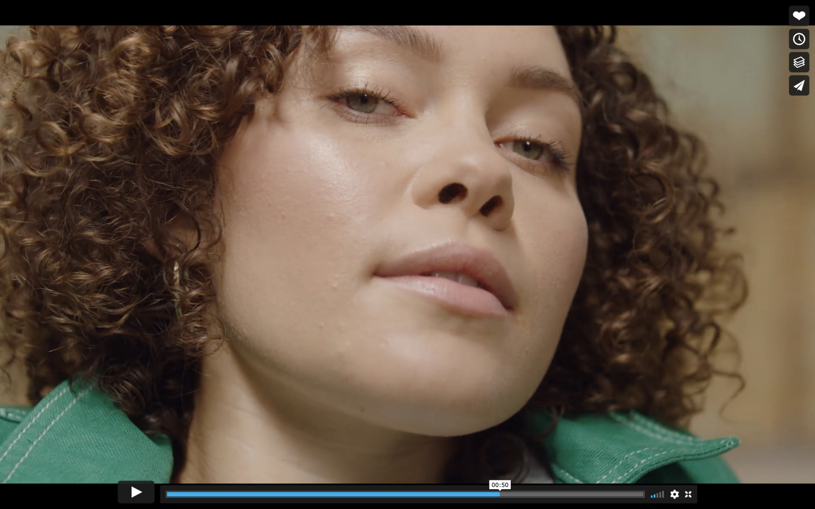 a close up of a person with curly hair