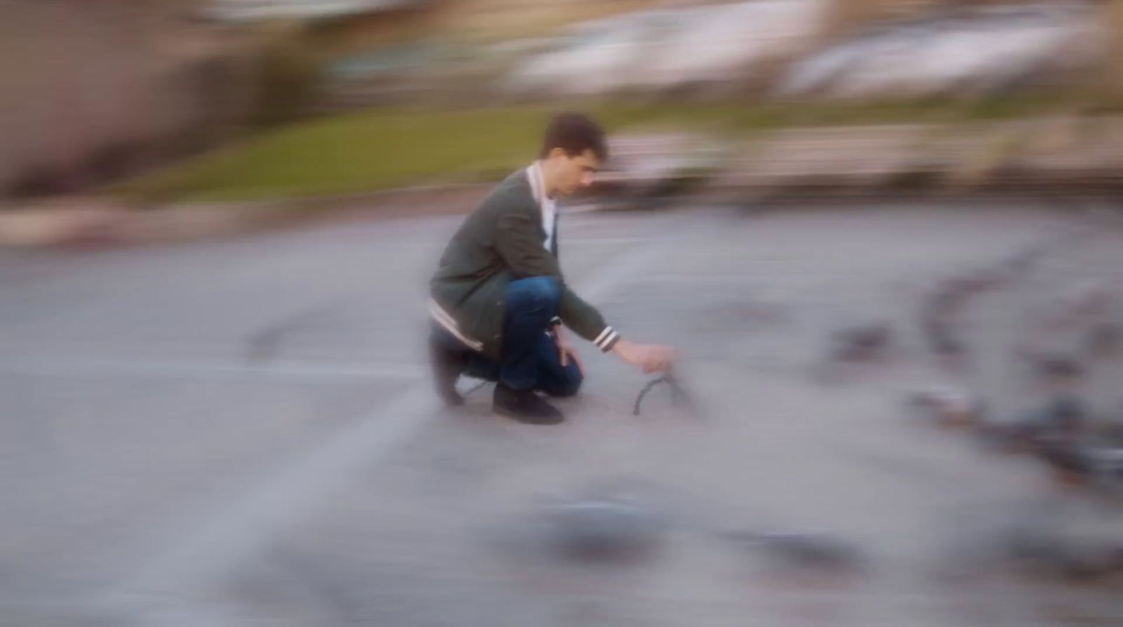 a blurry photo of a man kneeling down