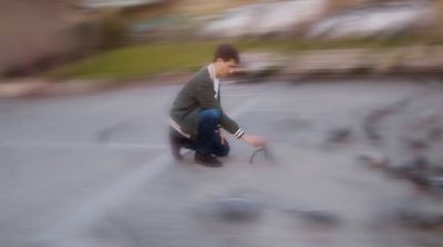 a blurry photo of a man kneeling down