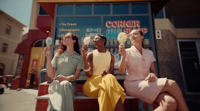 a group of women sitting on top of a bench