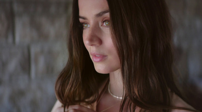 a close up of a woman wearing a necklace