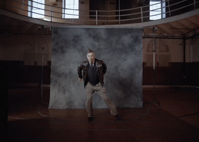 a man standing in front of a black backdrop