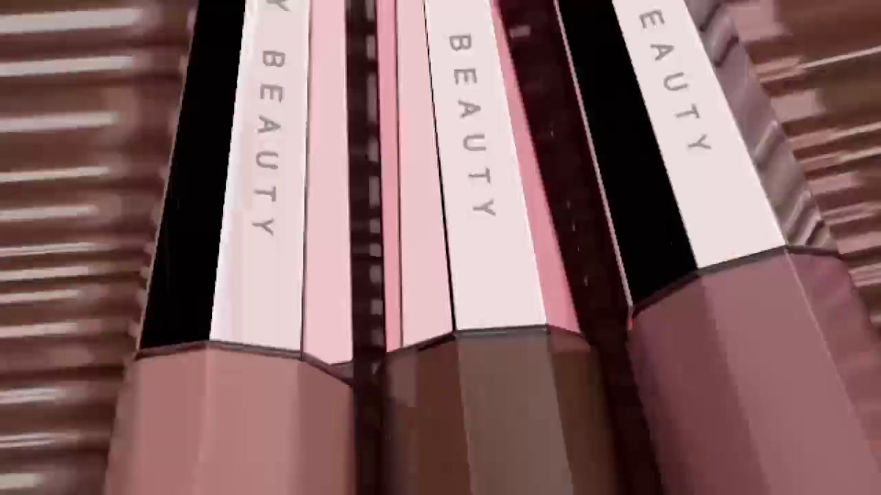 a close up of three lipsticks on a table