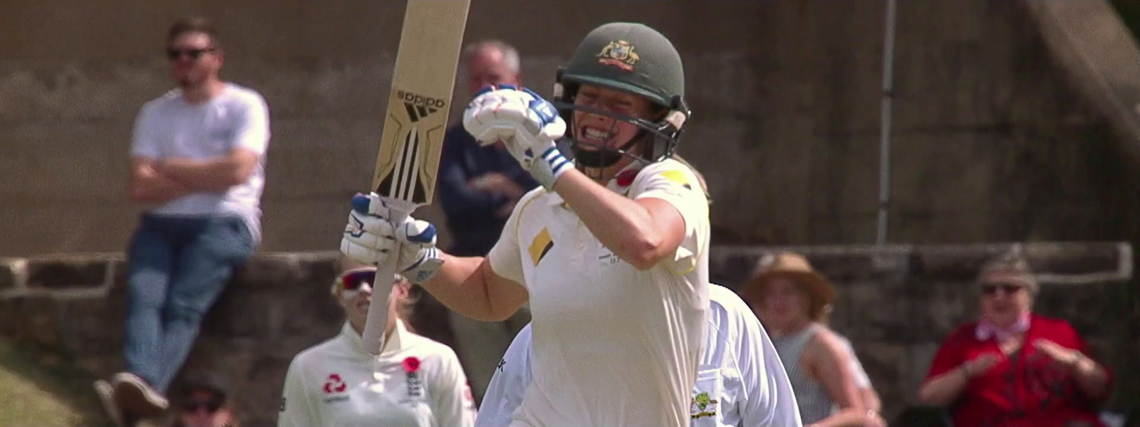 a man holding a cricket bat on a field