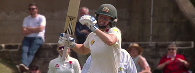 a man holding a cricket bat on a field