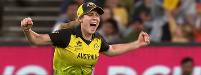 a woman in a yellow and black uniform is celebrating