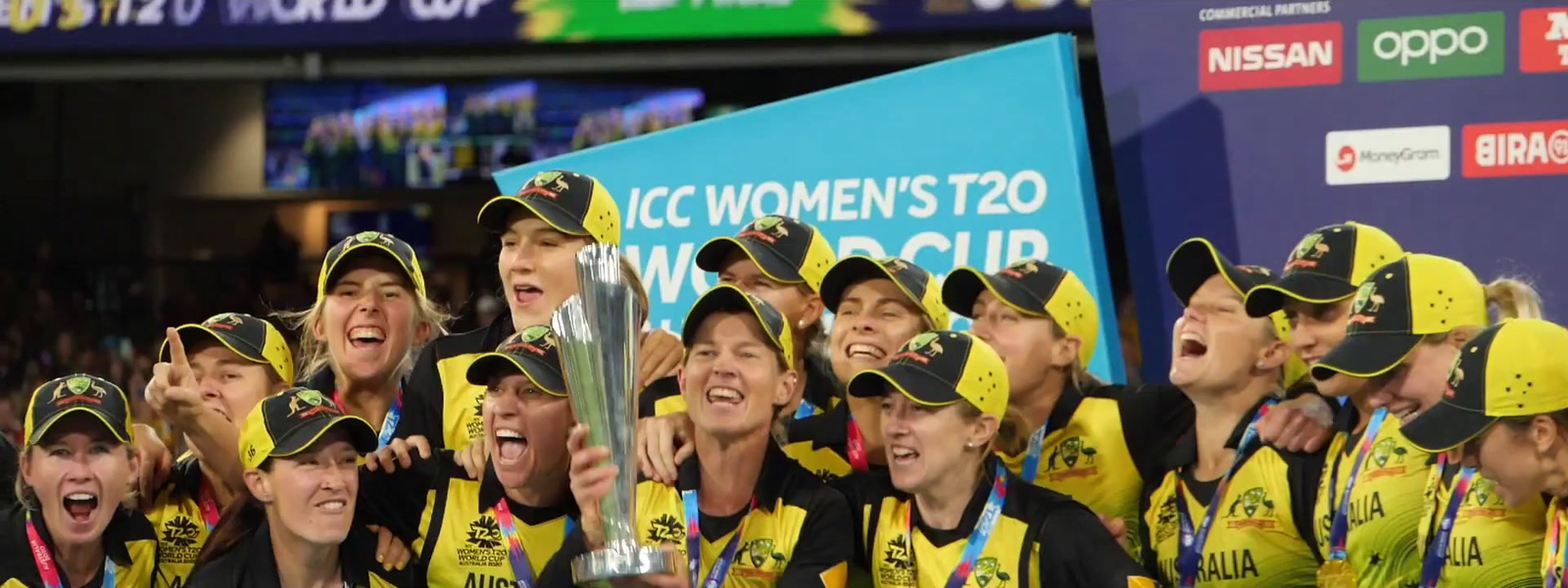 a group of women's soccer players holding a trophy