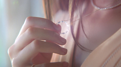 a close up of a person wearing a necklace