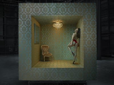 a woman in a room with a chair and a mirror