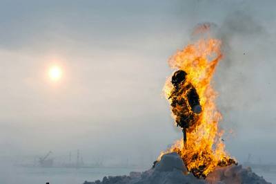 a person standing in front of a fire