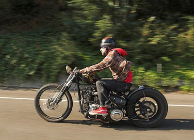 a man riding a motorcycle down a curvy road