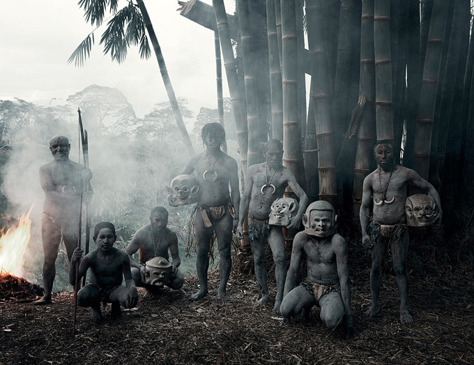 a group of people standing next to a fire