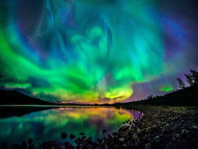 the aurora bore is reflected in the water