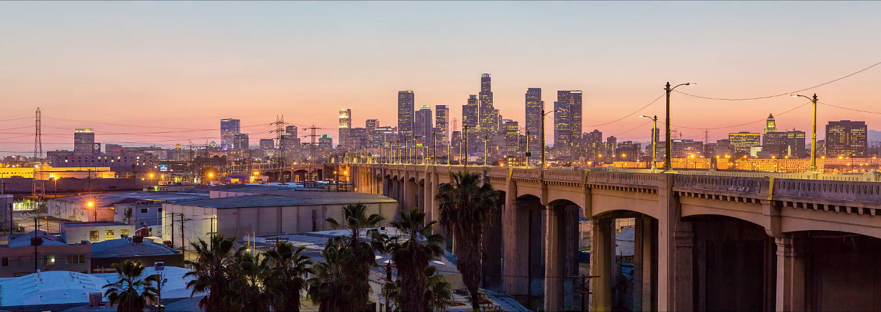 a view of a city skyline with a bridge in the foreground