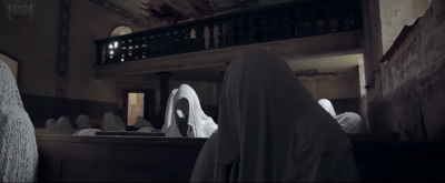 a nun is standing in front of a mirror