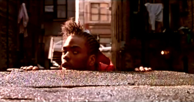 a woman with dreadlocks looking over a ledge