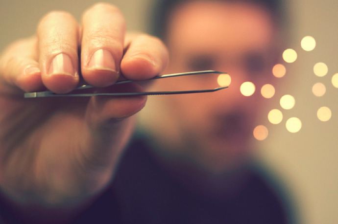 a man holding a pair of scissors in his hand