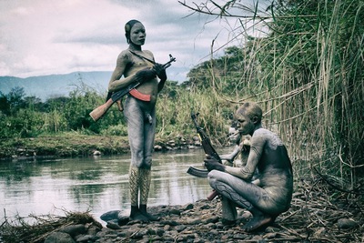 a man with a gun and a woman with a rifle