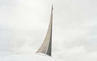 a very tall monument sitting on top of a snow covered hill