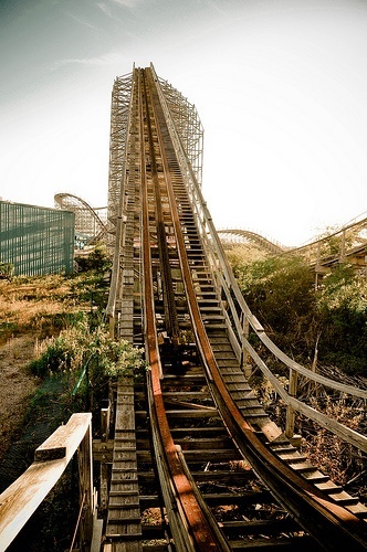 a wooden roller coaster going down a hill