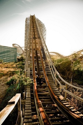 a wooden roller coaster going down a hill