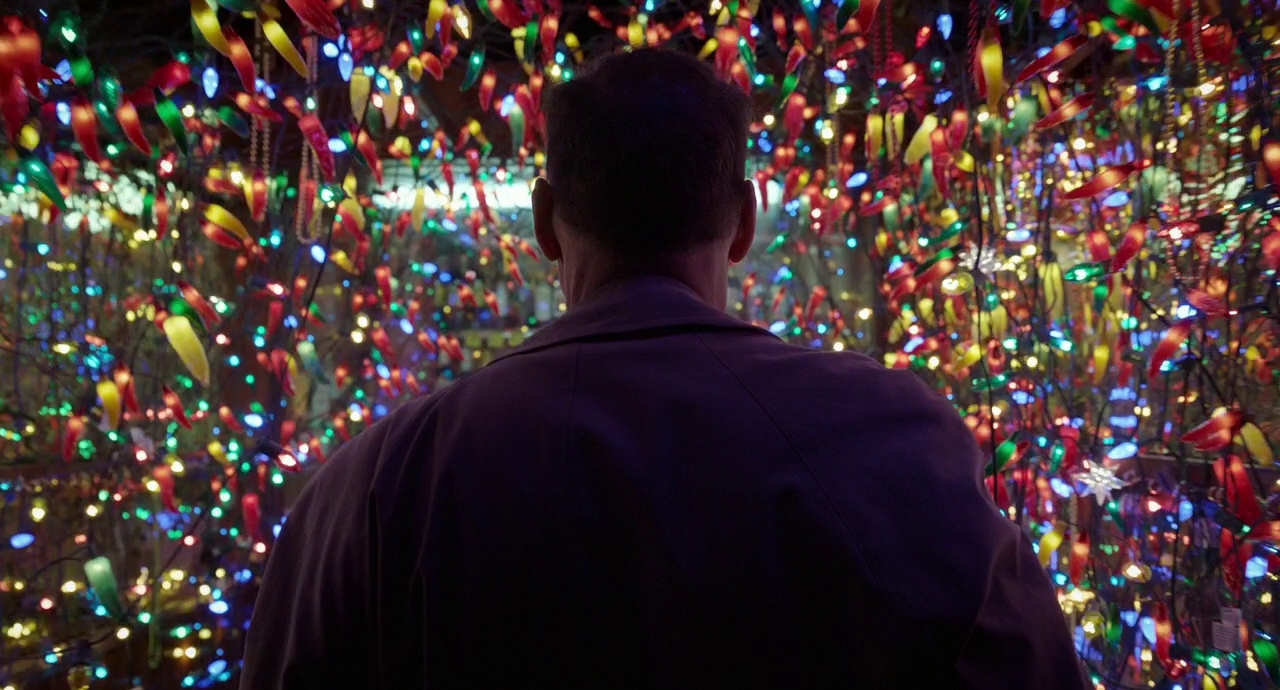 a man standing in front of a wall of lights