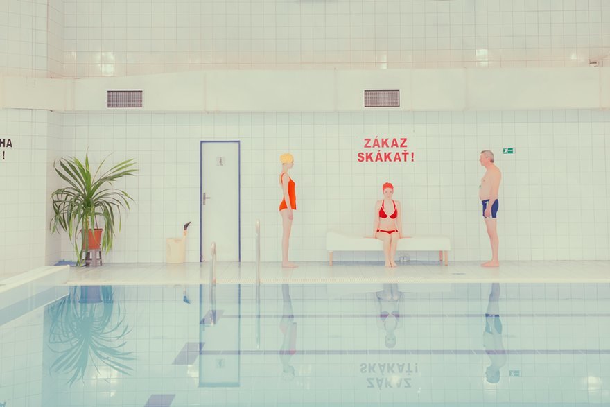 a group of people sitting on a bench in a swimming pool