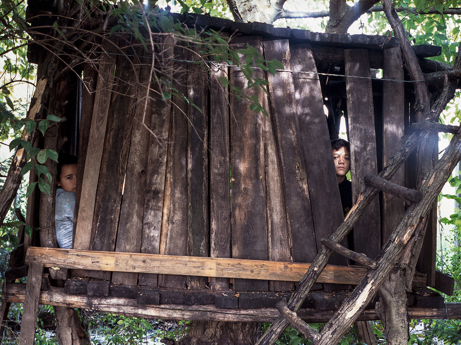 a couple of people standing on a wooden structure