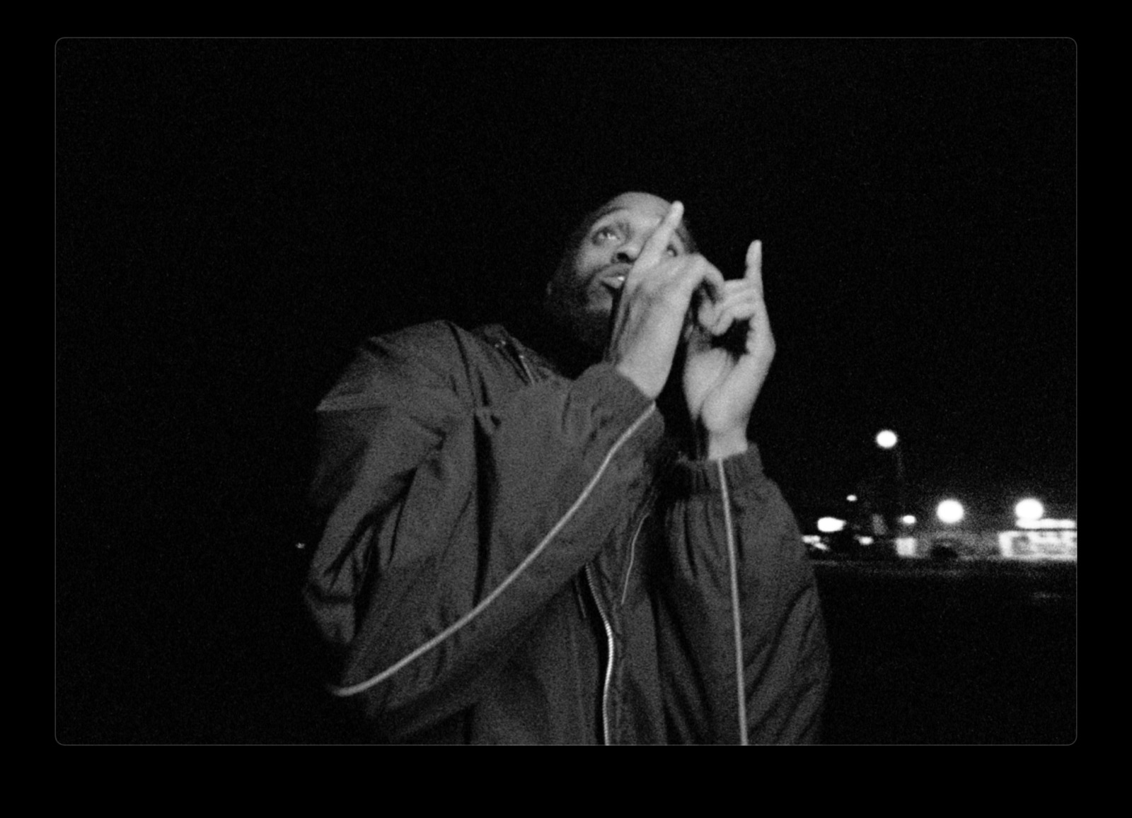 a black and white photo of a man holding a microphone