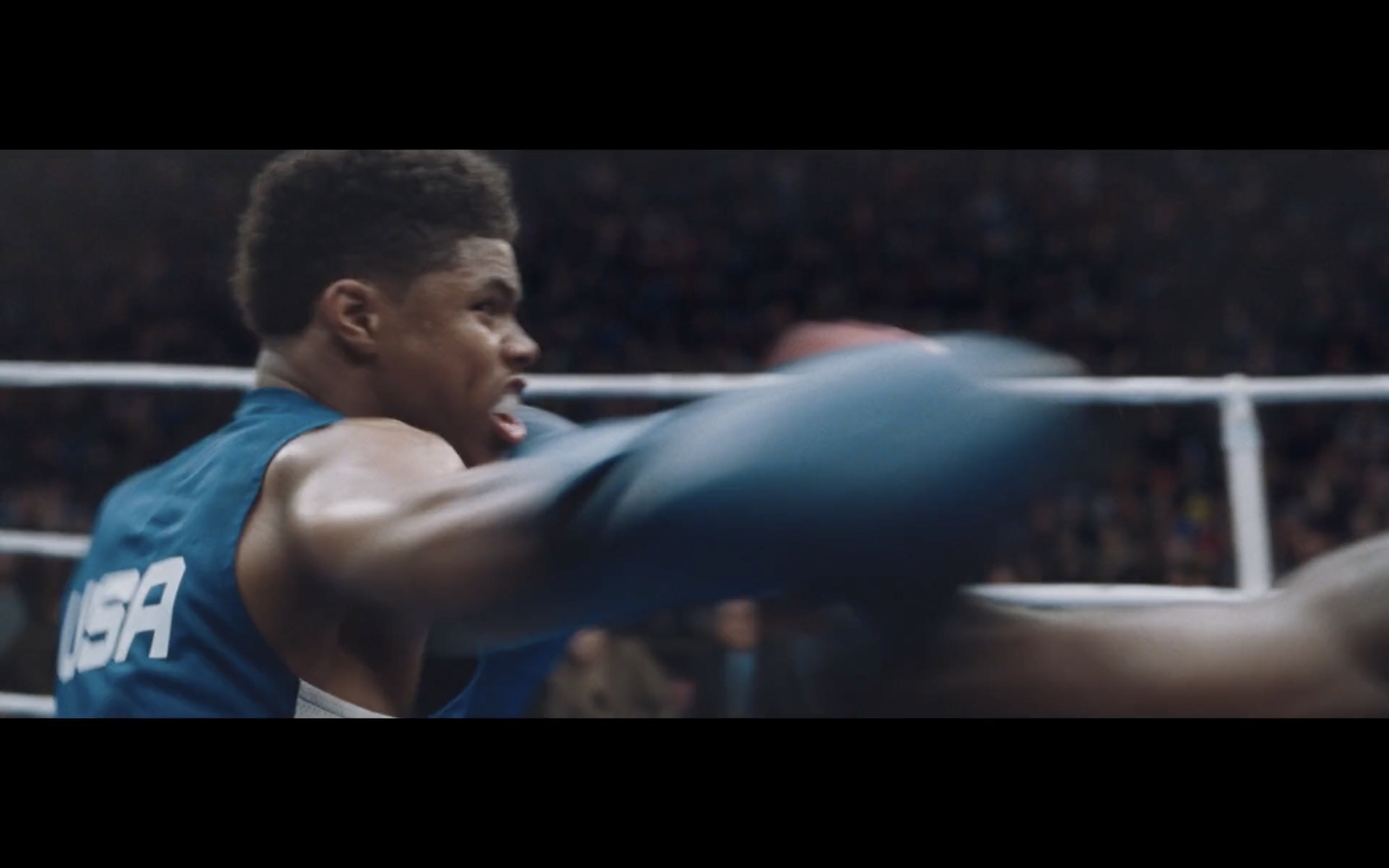 a man in a blue shirt is boxing