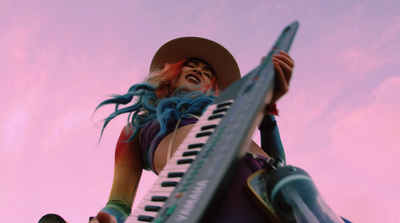 a woman with long blue hair and a hat holding a piano