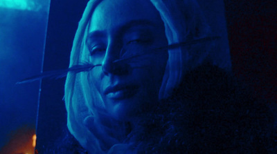 a woman with white hair and a blue background