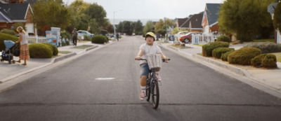 a person riding a bike down a street