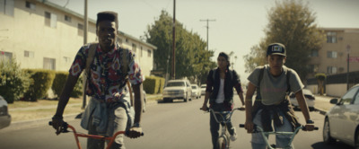 a group of people riding bikes down a street