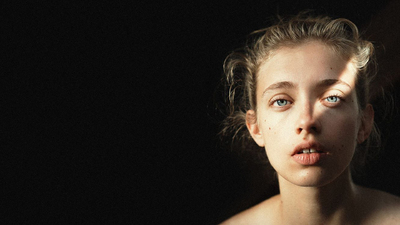 a close up of a woman with blue eyes