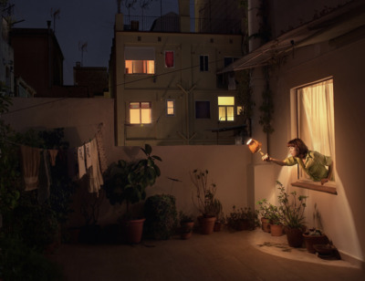 a woman is looking out of a window at night