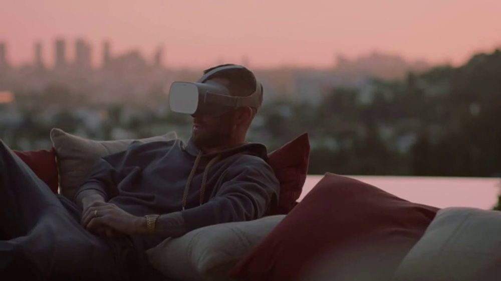 a man sitting on top of a couch wearing a blindfold