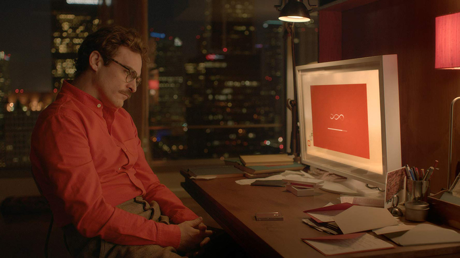 a man sitting at a desk in front of a computer