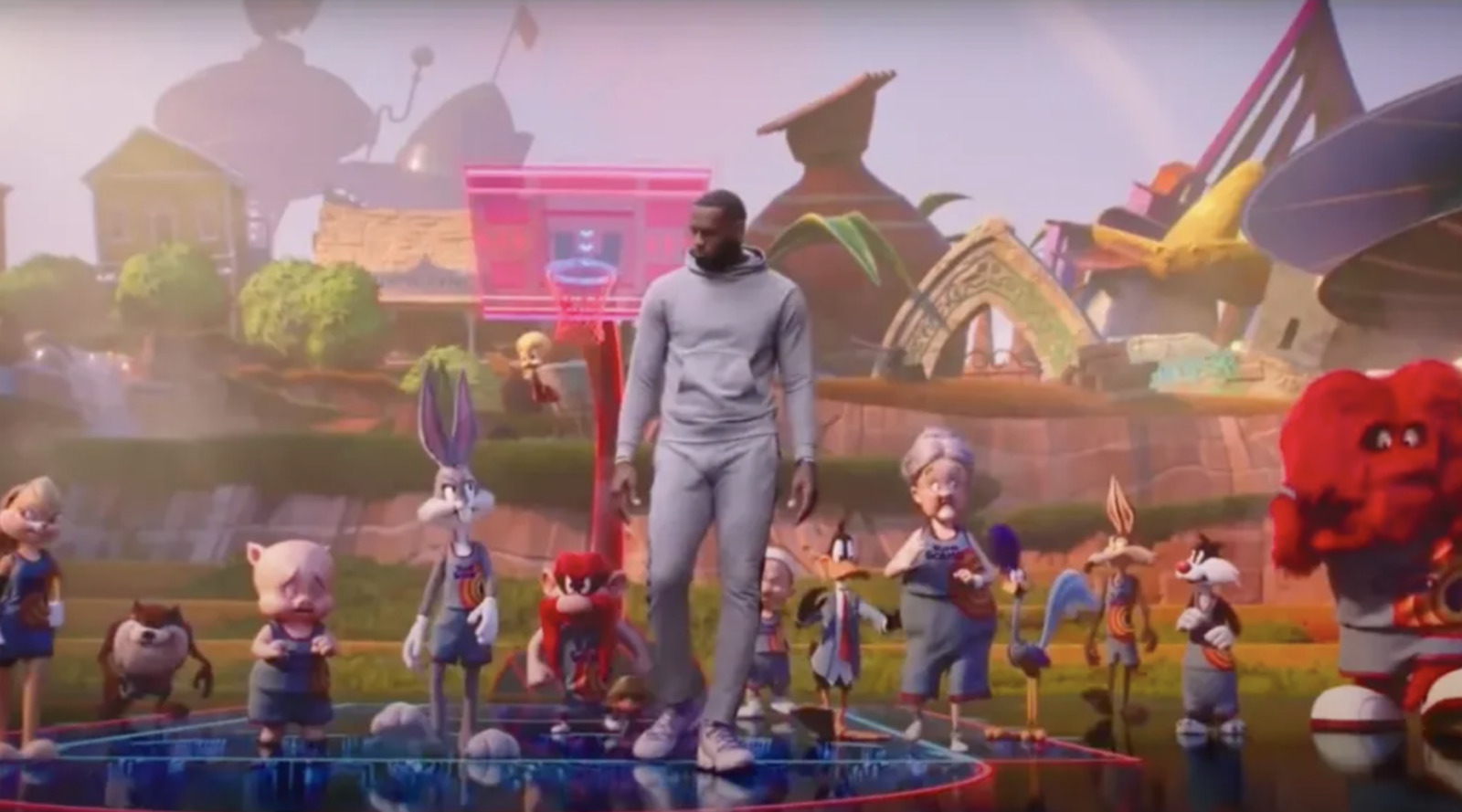 a man standing on top of a stage surrounded by cartoon characters