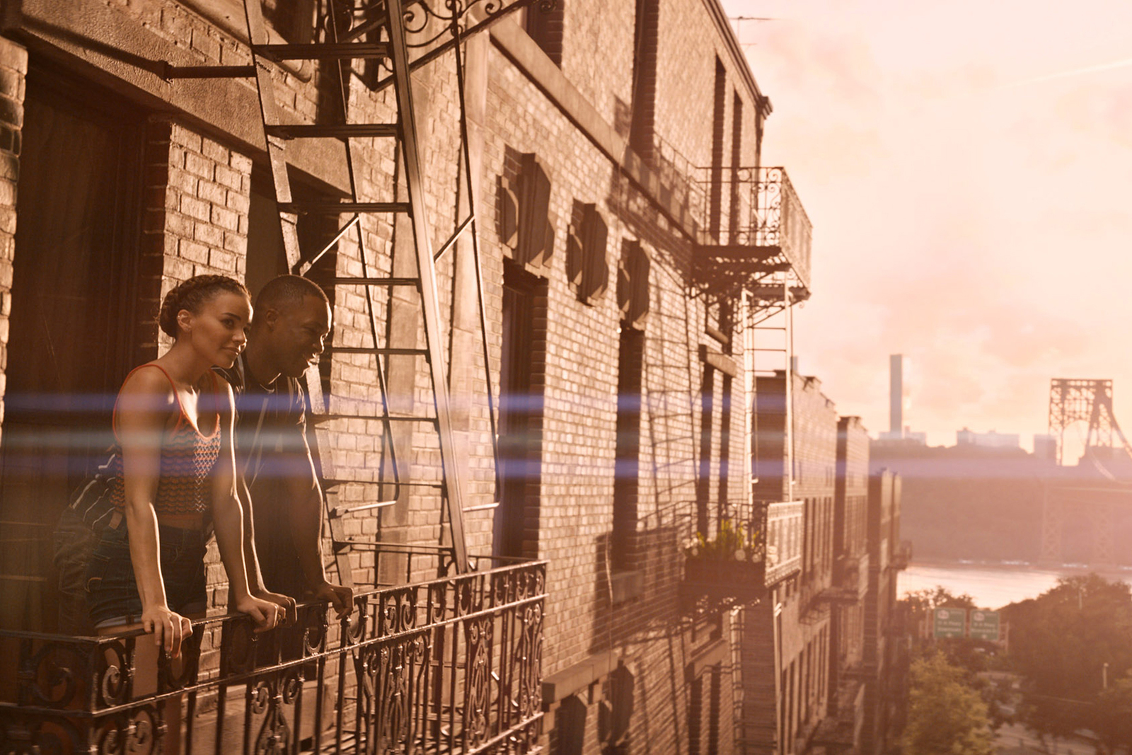 a man and a woman standing on a balcony