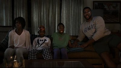 a group of people sitting on a couch in a living room