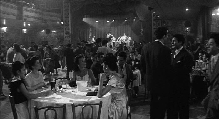 a group of people sitting around a table in a room