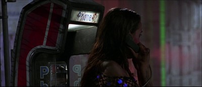 a woman talking on a cell phone next to a machine