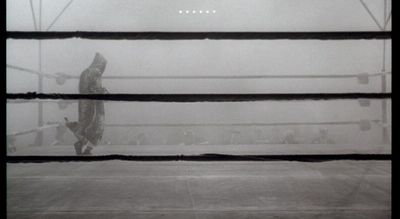 a black and white photo of a person in a boxing ring