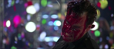 a man with a bloody face and red paint on his face