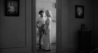 a man standing next to a woman in a doorway