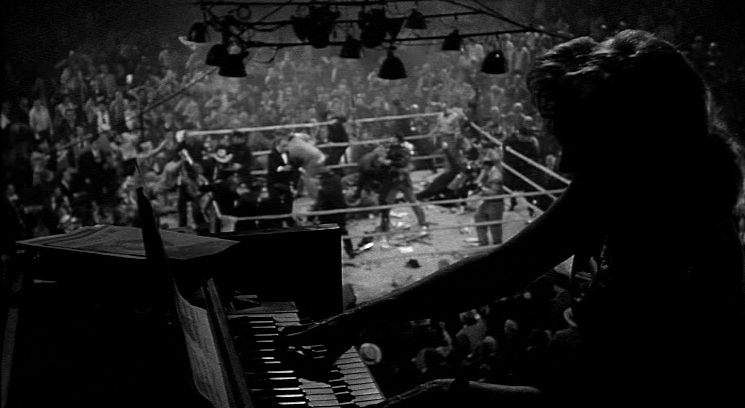 a person playing a piano in front of a crowd