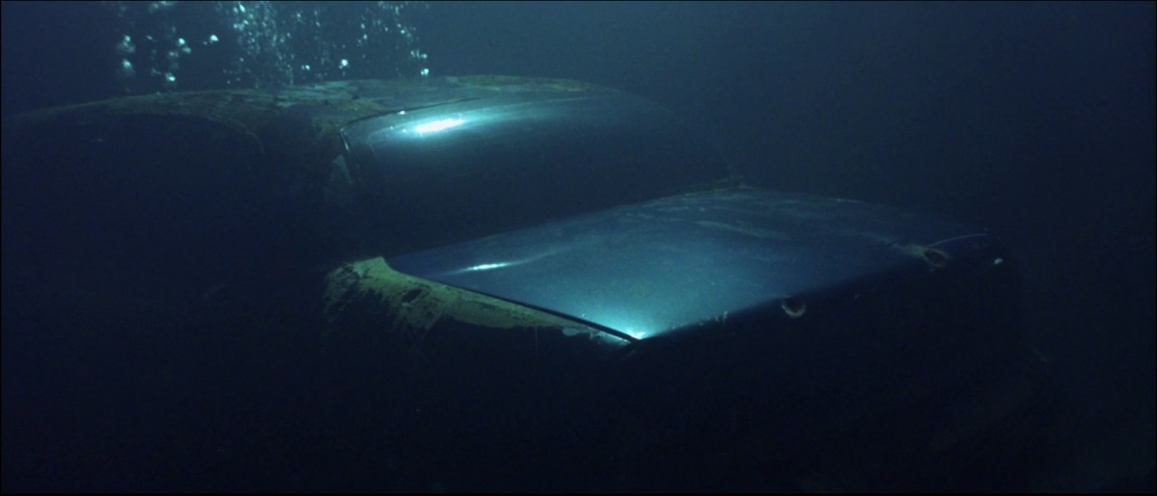 a car is submerged in the water at night