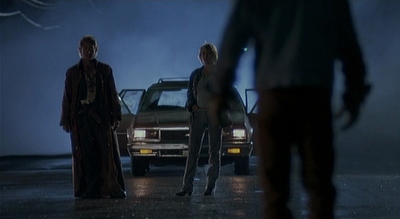 a group of people standing in front of a car